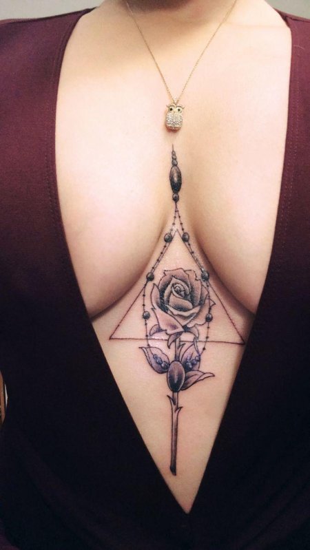 Татуировка между грудей