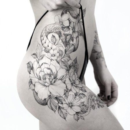 Женская татуировка на бедре